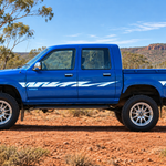 Blue Toyota Hilux in outback setting with chrome mag wheels