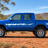 Blue Toyota Hilux in outback setting with chrome mag wheels