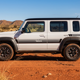 Five-door Suzuki Jimny with black and grey stripes in the Australian outback
