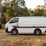 Large side view of the striped Toyota Hiace at a campsite without people