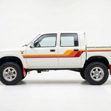 Left-facing Toyota Hilux dual cab with silver mag wheels and retro stripes