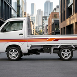 Suzuki Carry with red and orange stripes in a city setting