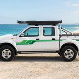 Ute facing left with a coastal background