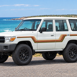 White 4WD at a front three-quarter angle beside the coast