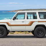 White 4WD with original stripes in an Australian coastal setting