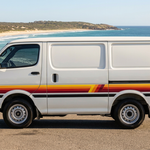 White HiAce with Palm Beach stripes in a sunny coastal setting