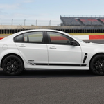 White Holden with black side stripes at a raceway
