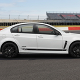 White Holden with black side stripes at a raceway