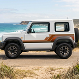 White Jimny with earth-tone stripes in an Australian coastal setting